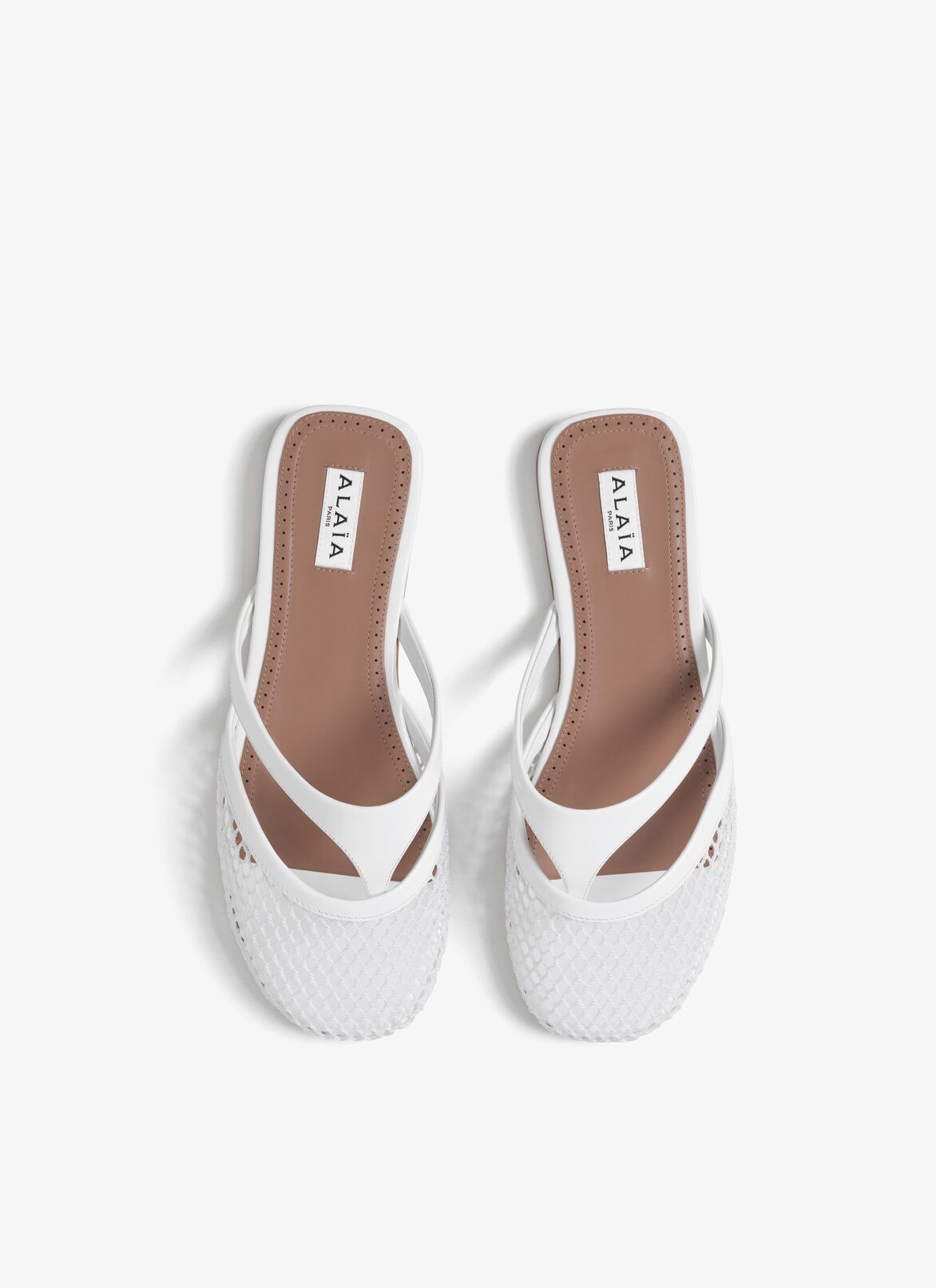 INFRADITO FLAT MULES IN FISHNET AND LEATHER ALAÏA OPTIC WHITE INFRADITO FLAT MULES IN FISHNET AND LEATHER